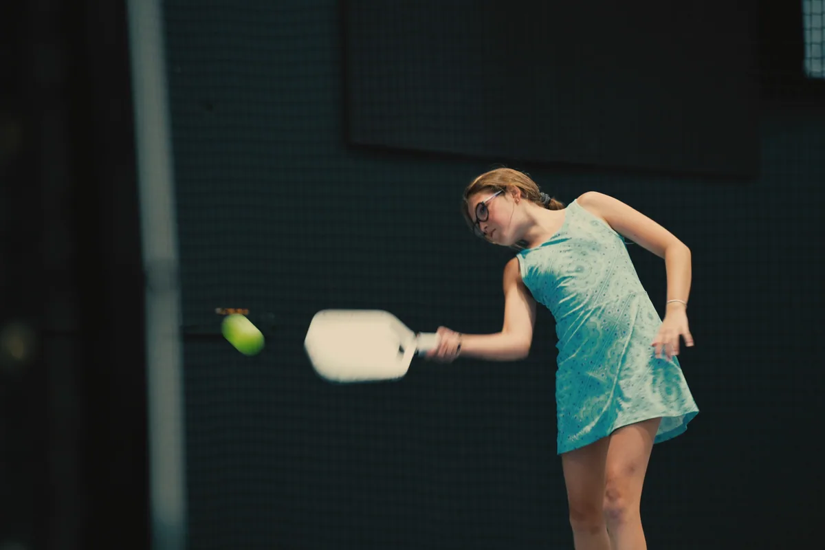 Junior player practicing a forehand inside the club.