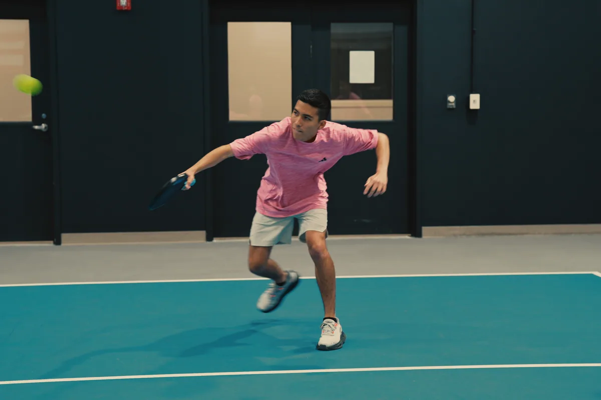 Junior player making a controlled shot inside the club.